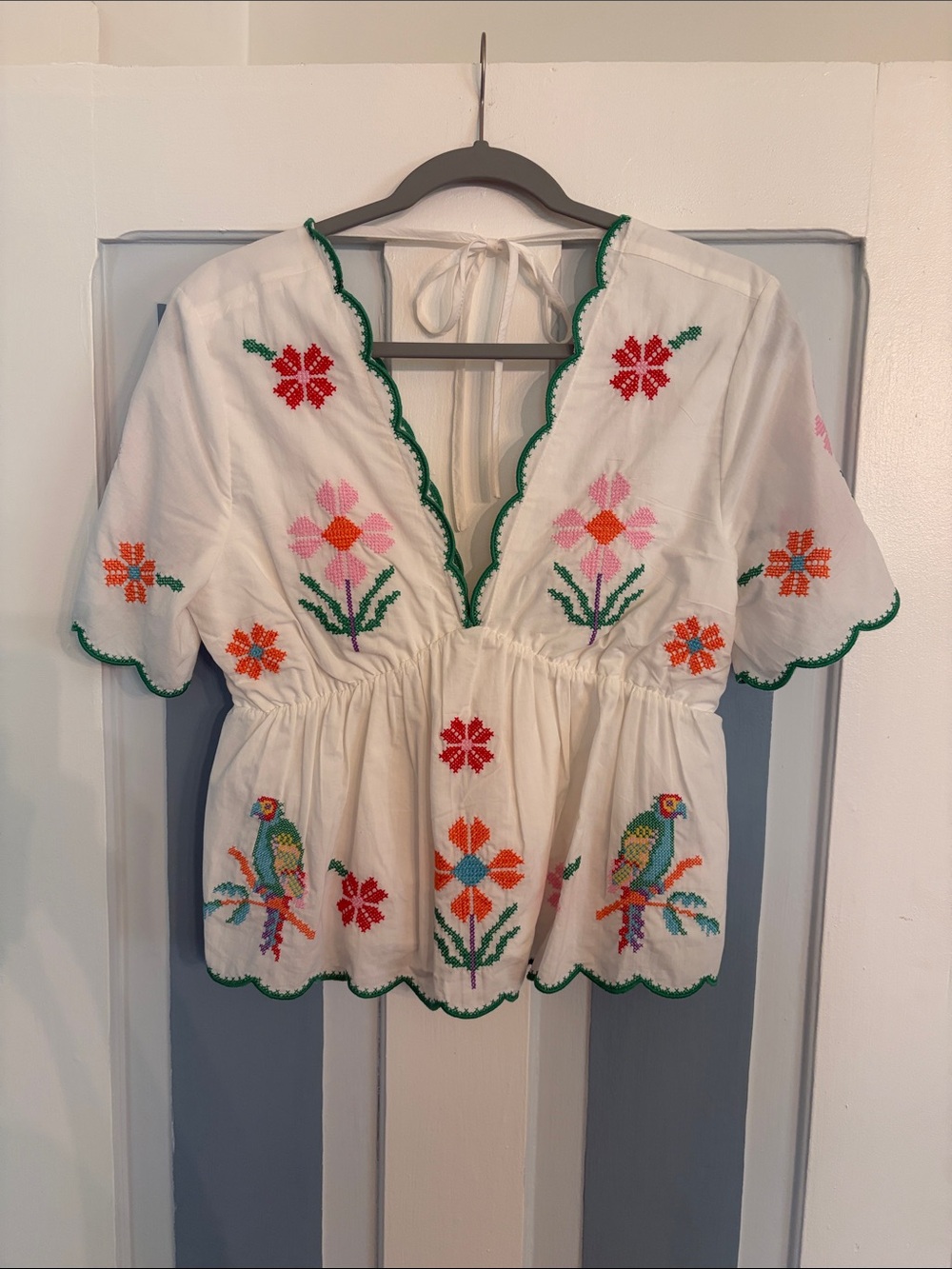 Eloise Top- White Embroidered Peplum Blouse with Floral and Parrot Motif